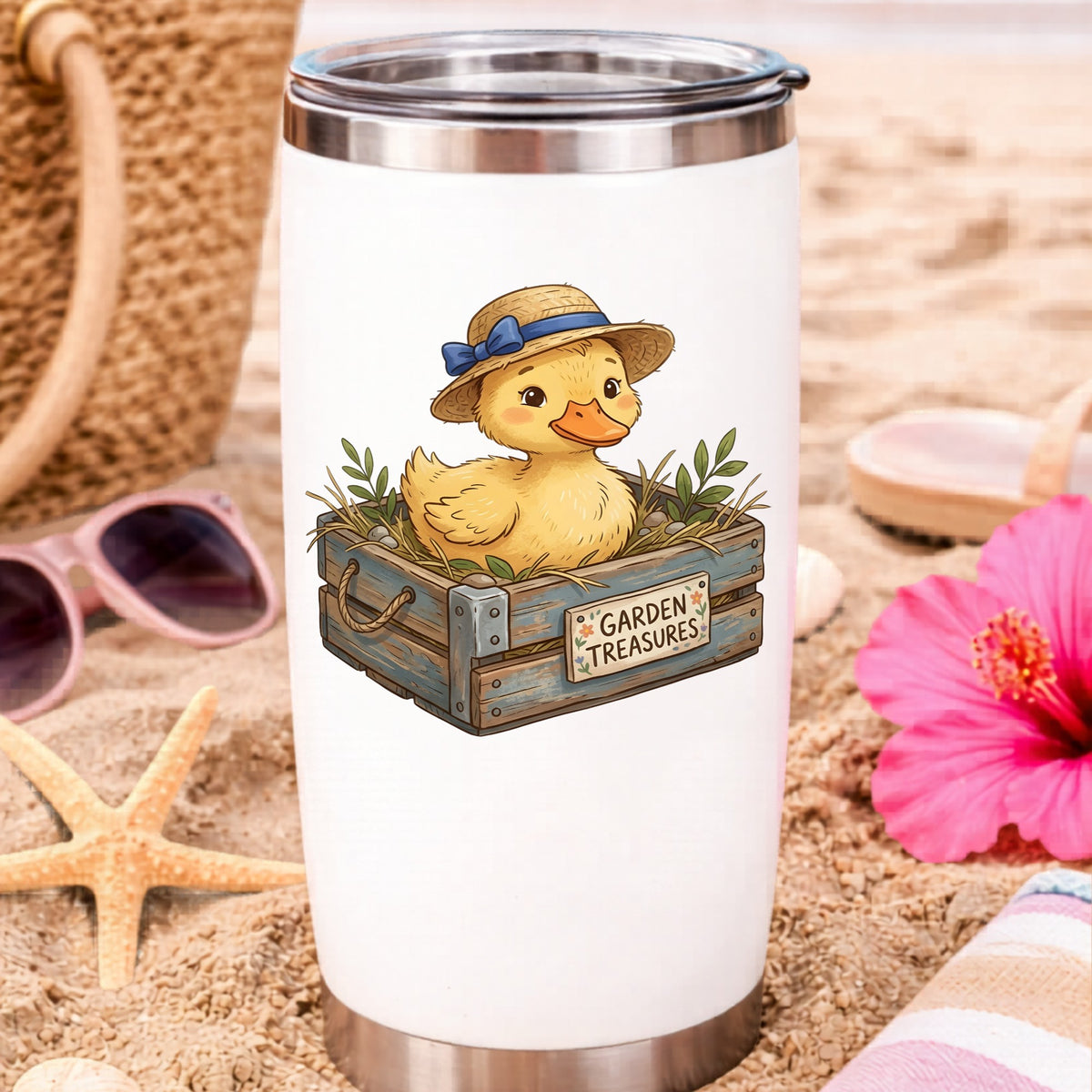 Duckling In Garden Treasures Crate UV DTF sticker applied to a white travel tumbler on beach sand