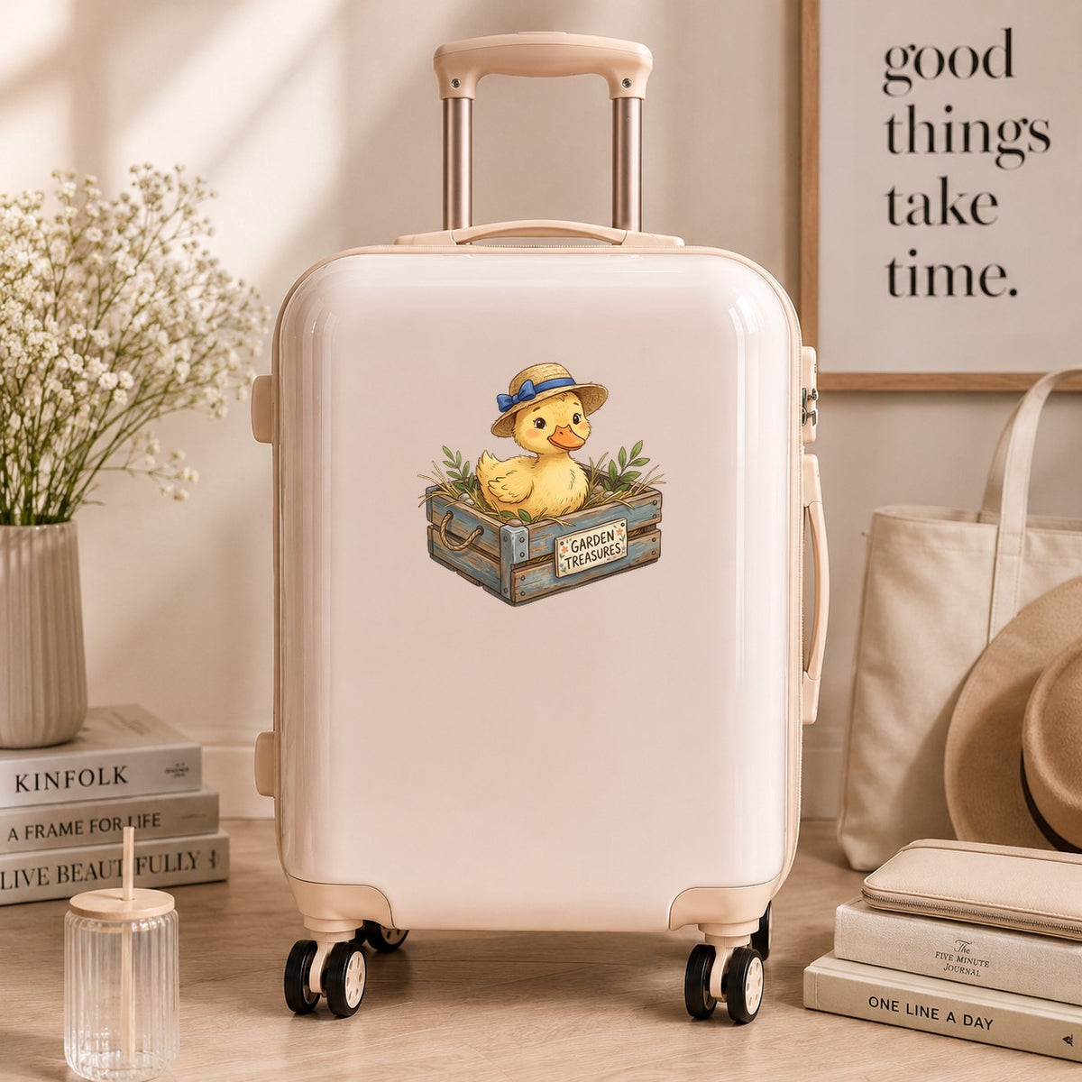Duckling In Garden Treasures Crate UV DTF sticker applied to a cream carry-on suitcase