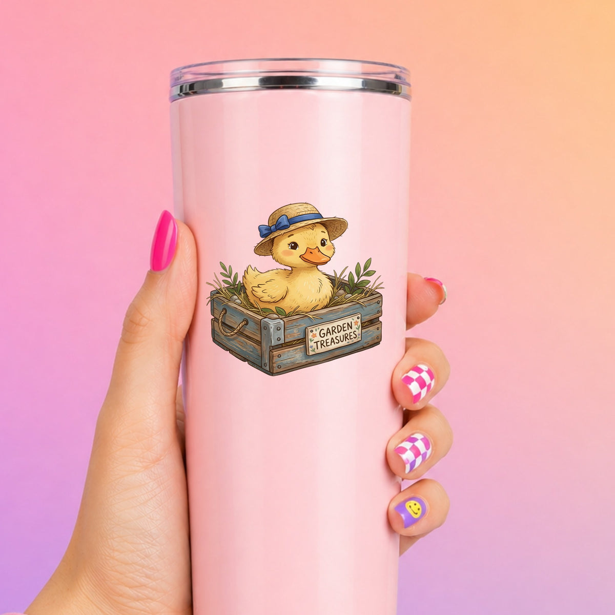 Duckling In Garden Treasures Crate UV DTF sticker applied to a tall pink tumbler on a pink and orange background