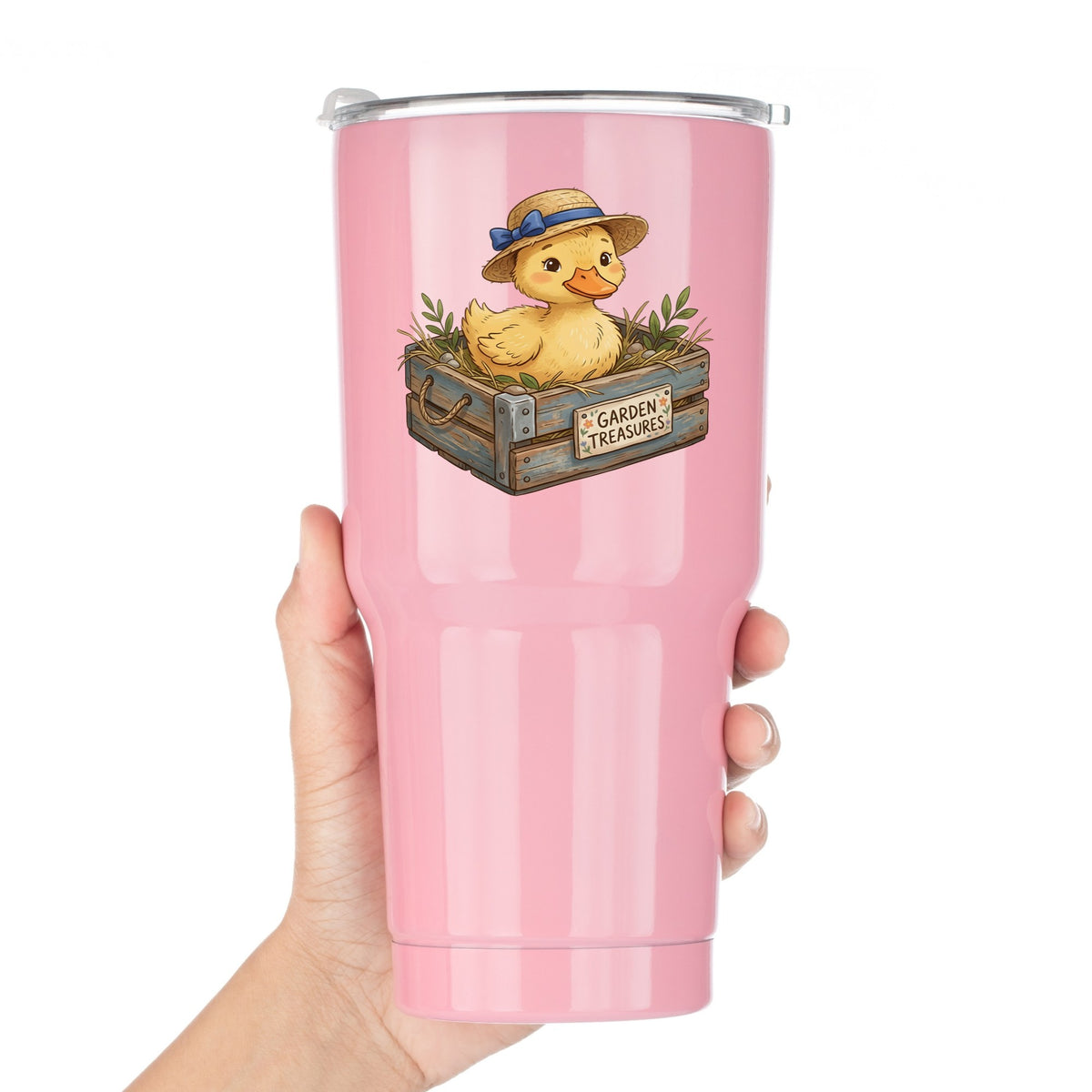 Duckling In Garden Treasures Crate UV DTF sticker applied to a pink tumbler held against a white background