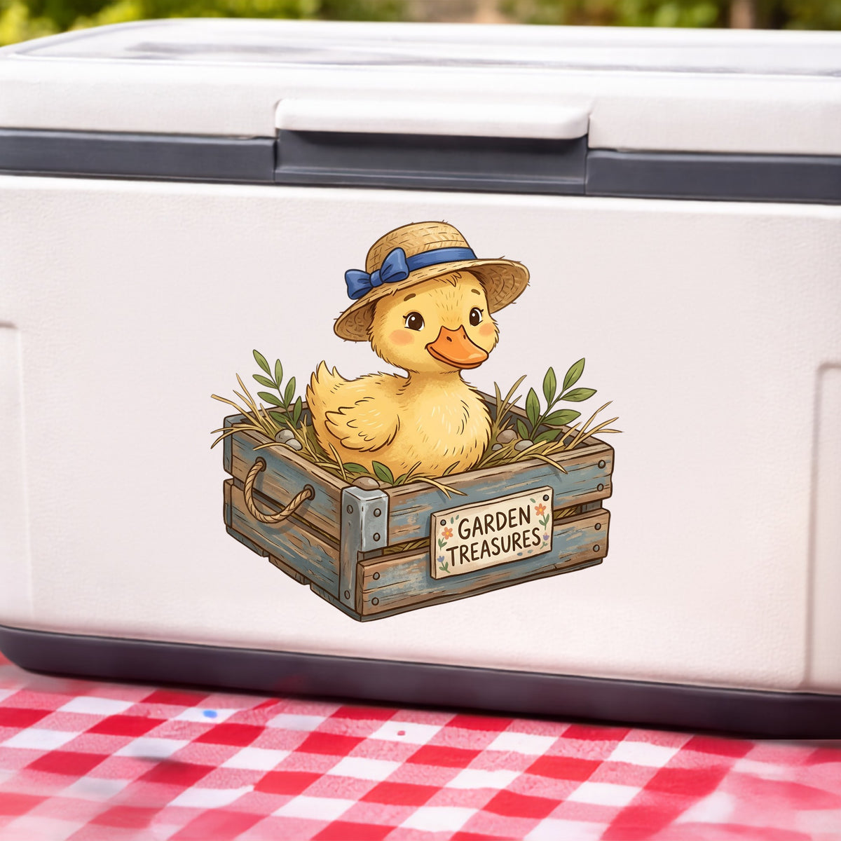 Duckling In Garden Treasures Crate UV DTF sticker applied to a white cooler on a red gingham cloth