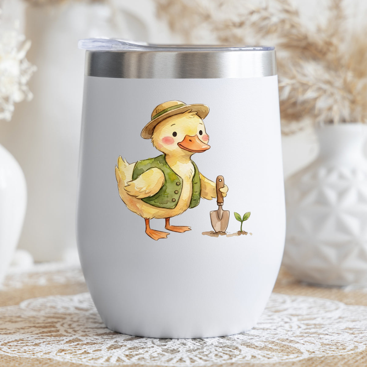 Duck In Green Vest With Garden Trowel UV DTF sticker applied to a white stemless tumbler with a lid