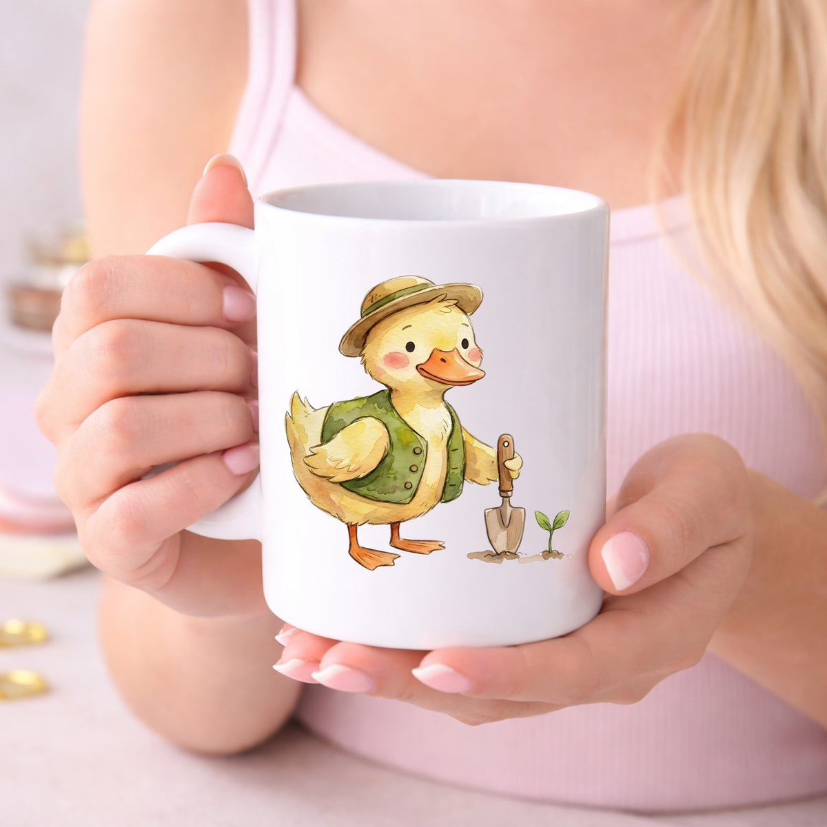 Duck In Green Vest With Garden Trowel UV DTF sticker applied to a white coffee mug held in both hands