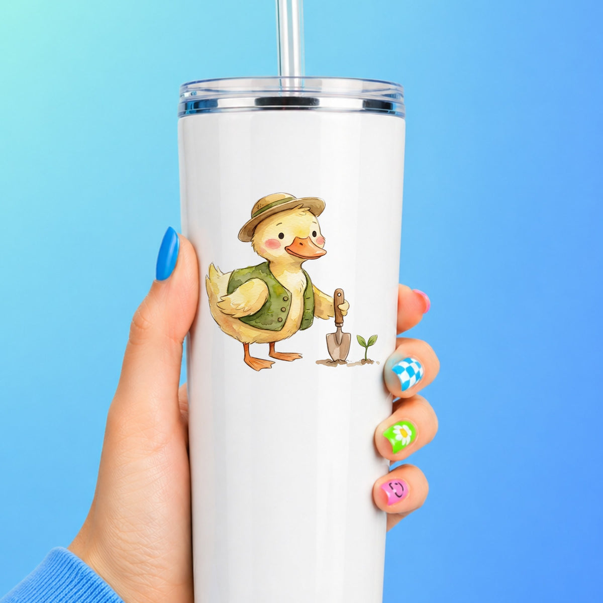 Duck In Green Vest With Garden Trowel UV DTF sticker applied to a white straw tumbler on a blue background