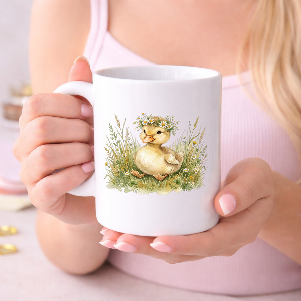 Duckling With Daisy Crown In Grass UV DTF sticker applied to a white coffee mug held in both hands