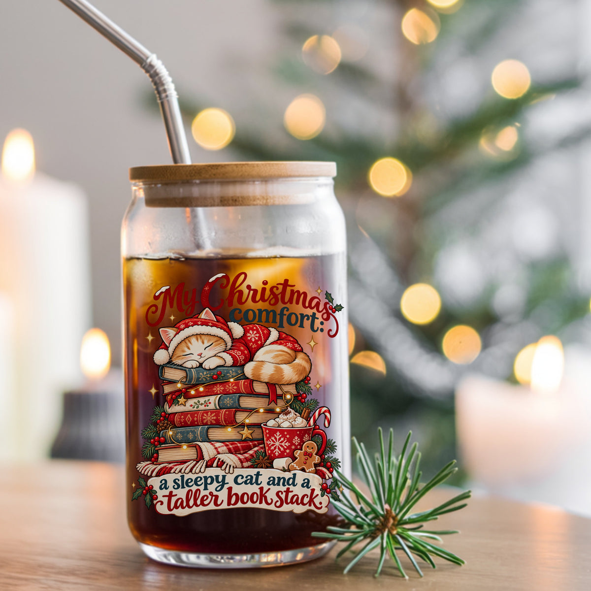 Sleepy Christmas Cat On Book Stack UV DTF sticker applied to a glass can cup of iced coffee with a straw