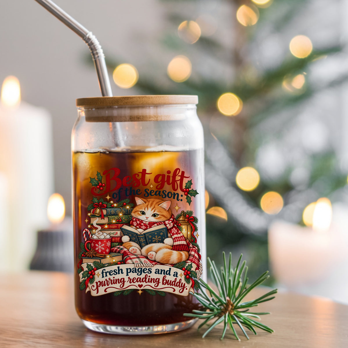 Christmas Cat Reading A Book UV DTF sticker applied to a glass can cup of iced coffee with a straw