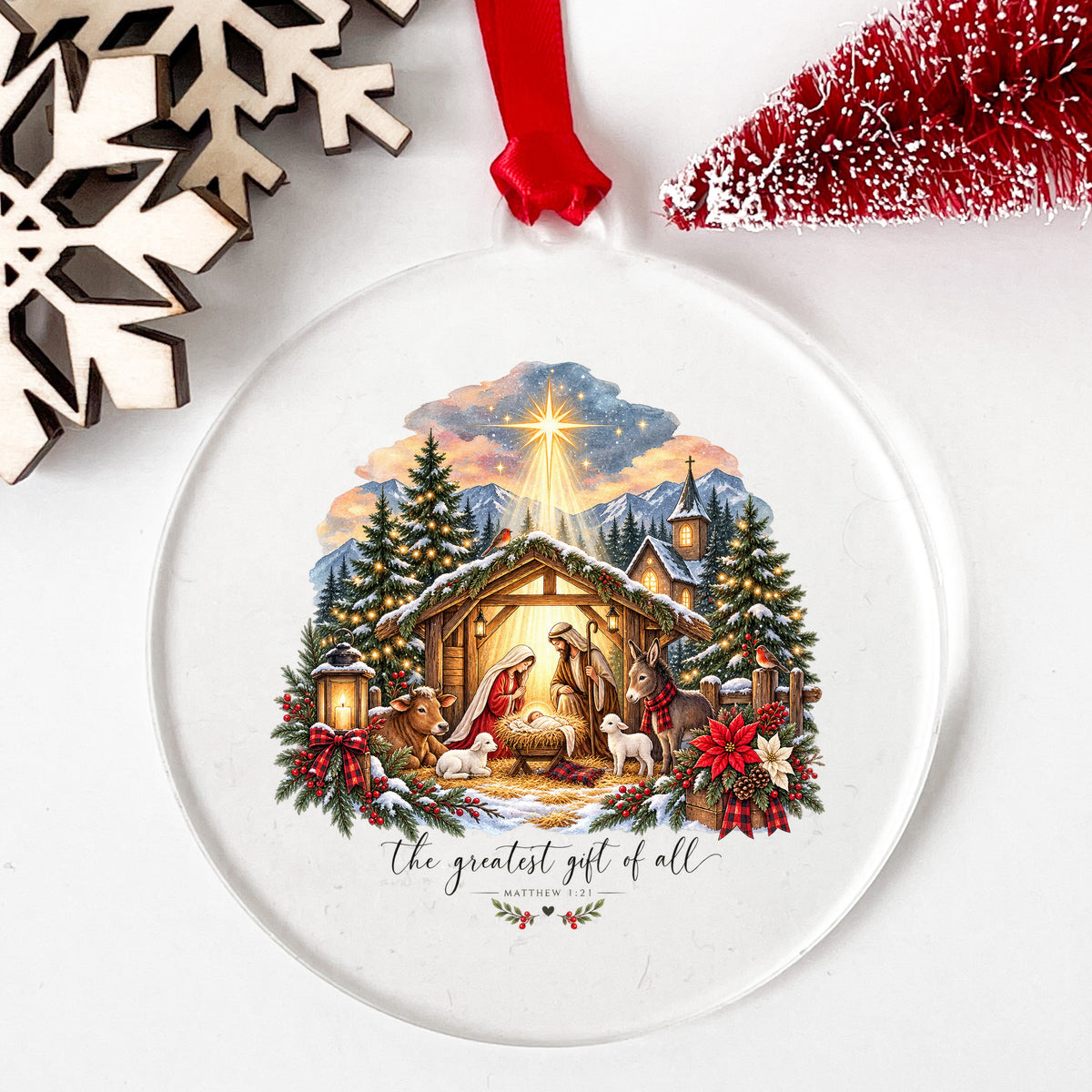 Greatest Gift Of All Nativity Stable UV DTF sticker applied to a clear round acrylic ornament with a red ribbon