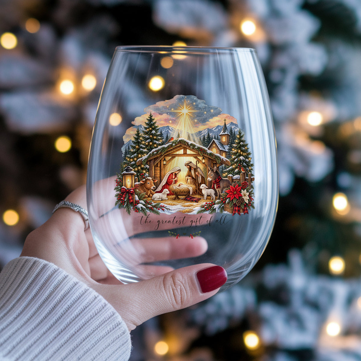 Greatest Gift Of All Nativity Stable UV DTF sticker applied to a stemless wine glass held in hand