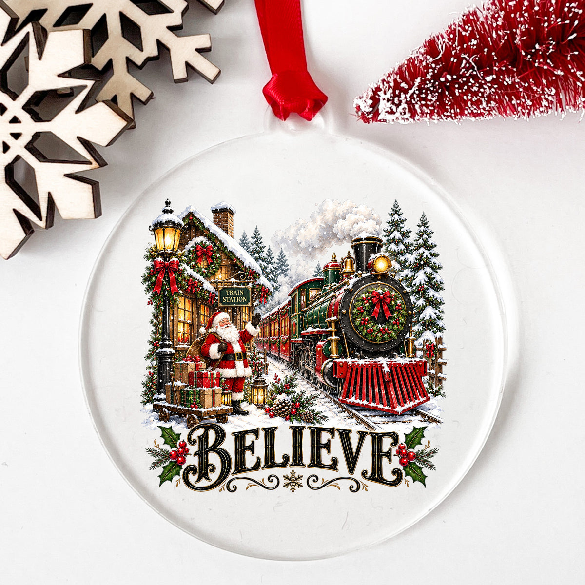 Believe Santa Christmas Train Station UV DTF sticker applied to a clear round acrylic ornament with a red ribbon