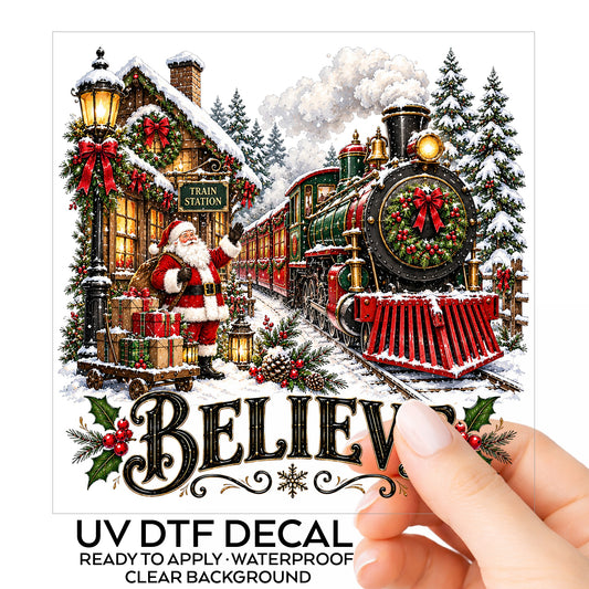 Believe Santa Christmas Train Station UV DTF sticker on its backing card, held in hand