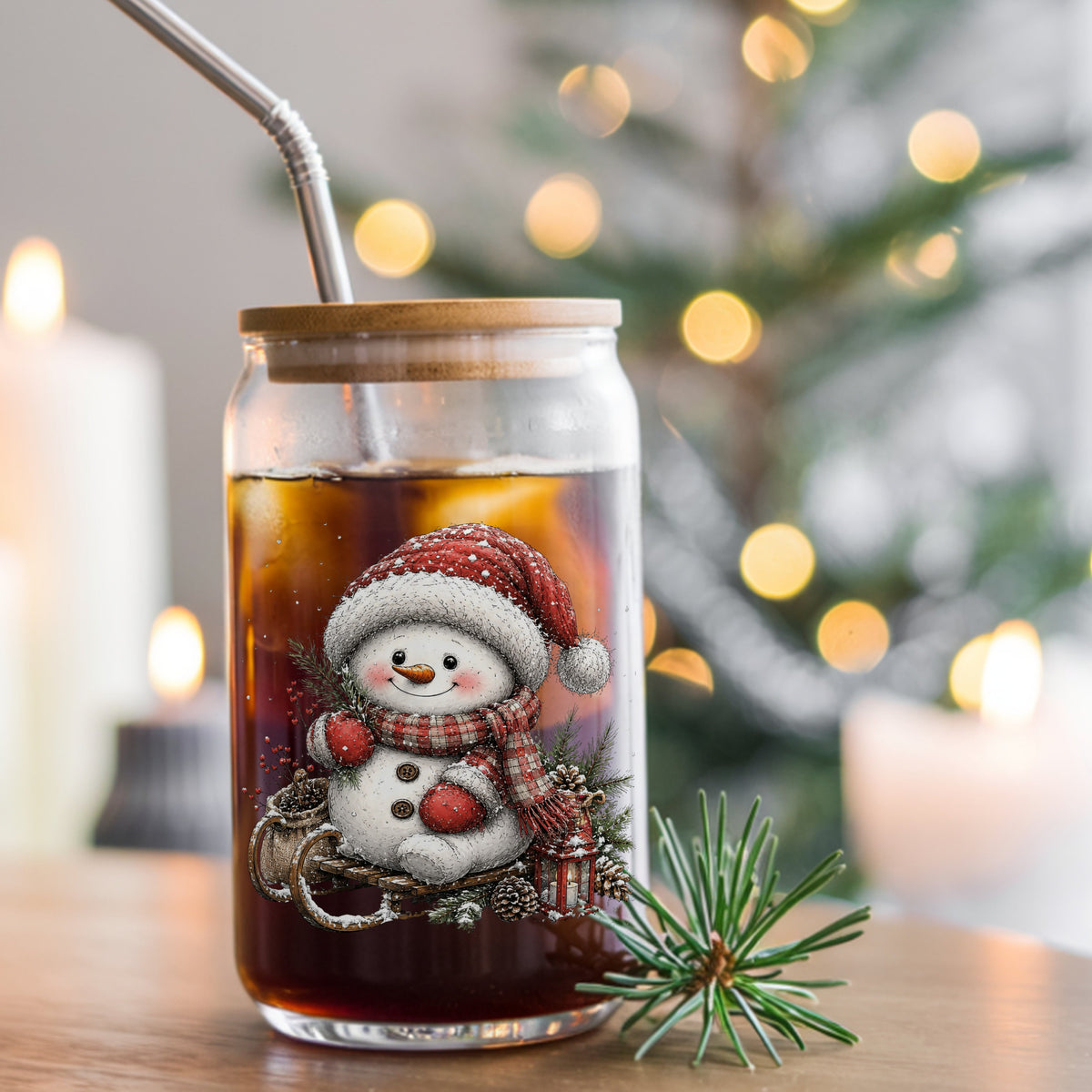 Snowman On Wooden Sled UV DTF sticker applied to a glass can cup of iced coffee with a straw