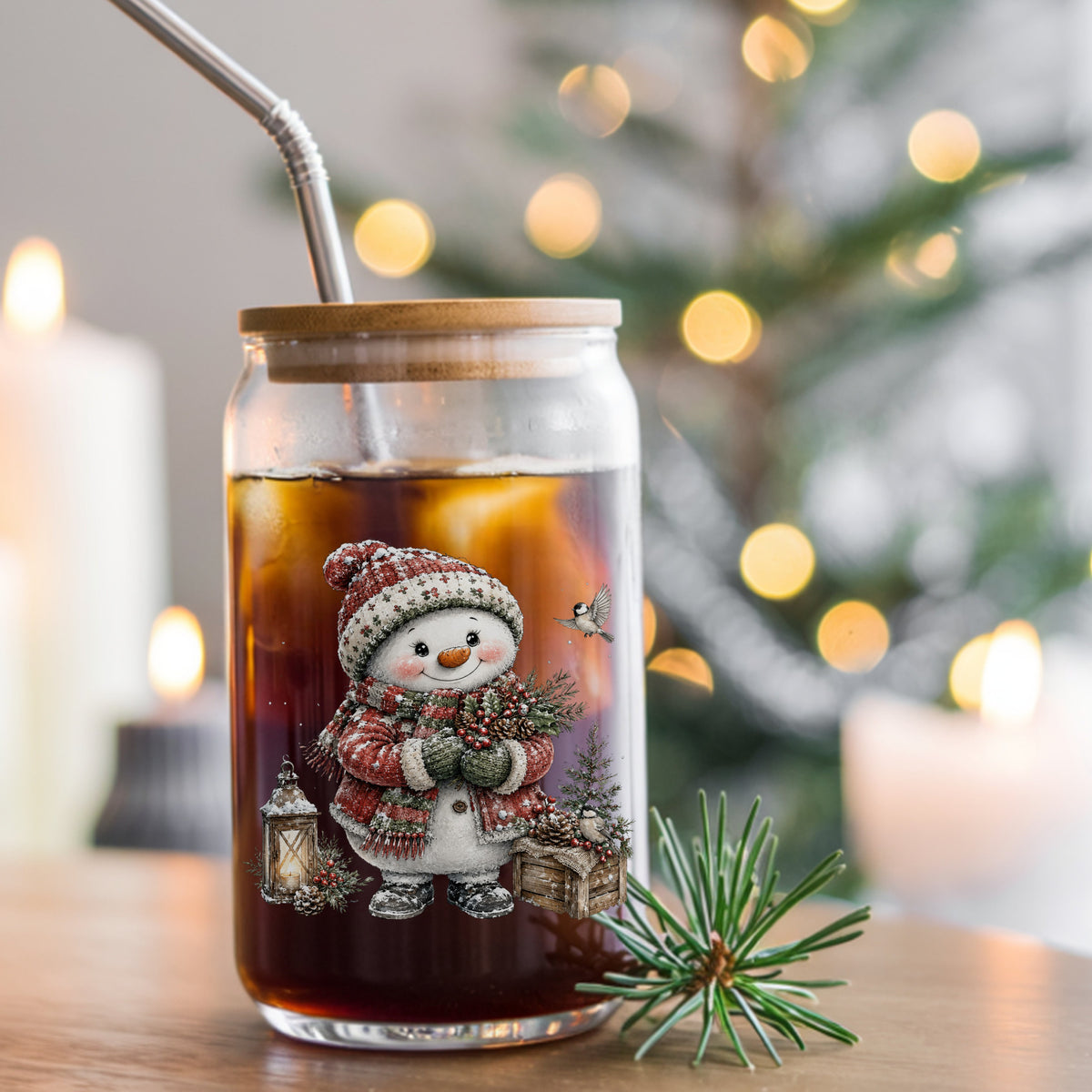 Snowman In Red Sweater Holding Holly UV DTF sticker applied to a glass can cup of iced coffee with a straw