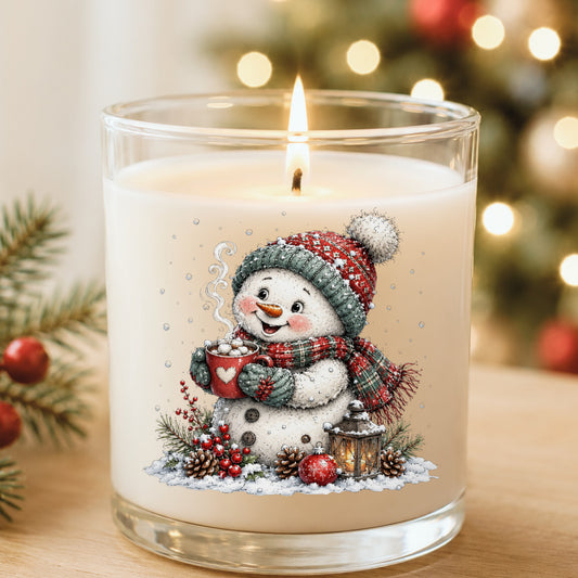 Hot Cocoa Snowman With Heart Mug UV DTF sticker applied to a white candle in a glass holder near Christmas lights
