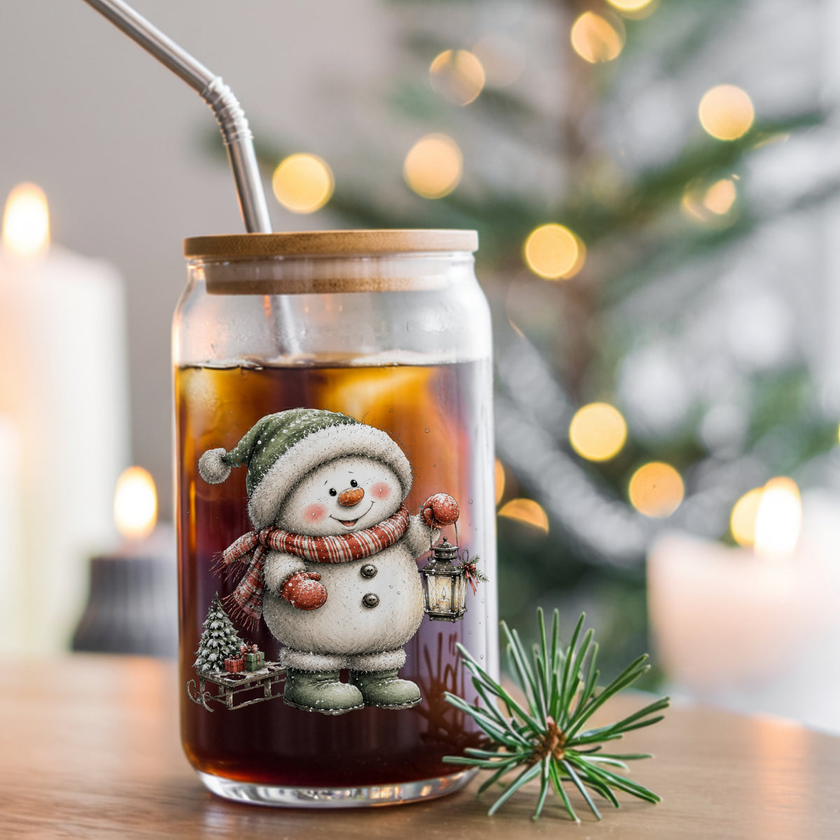 Green Hat Snowman With Sled And Gifts UV DTF sticker applied to a glass can cup of iced coffee with a straw