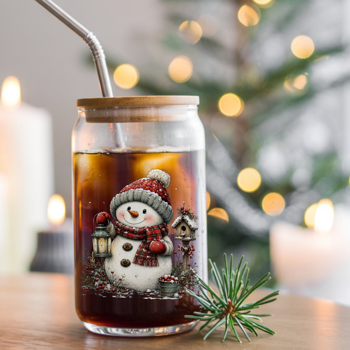Snowman With Birdhouse And Berry Bucket UV DTF sticker applied to a glass can cup of iced coffee with a straw