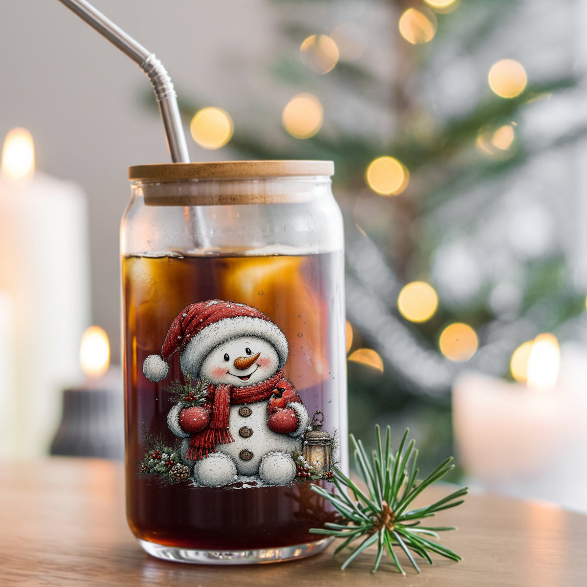 Snowman Holding Red Cardinal UV DTF sticker applied to a glass can cup of iced coffee with a straw