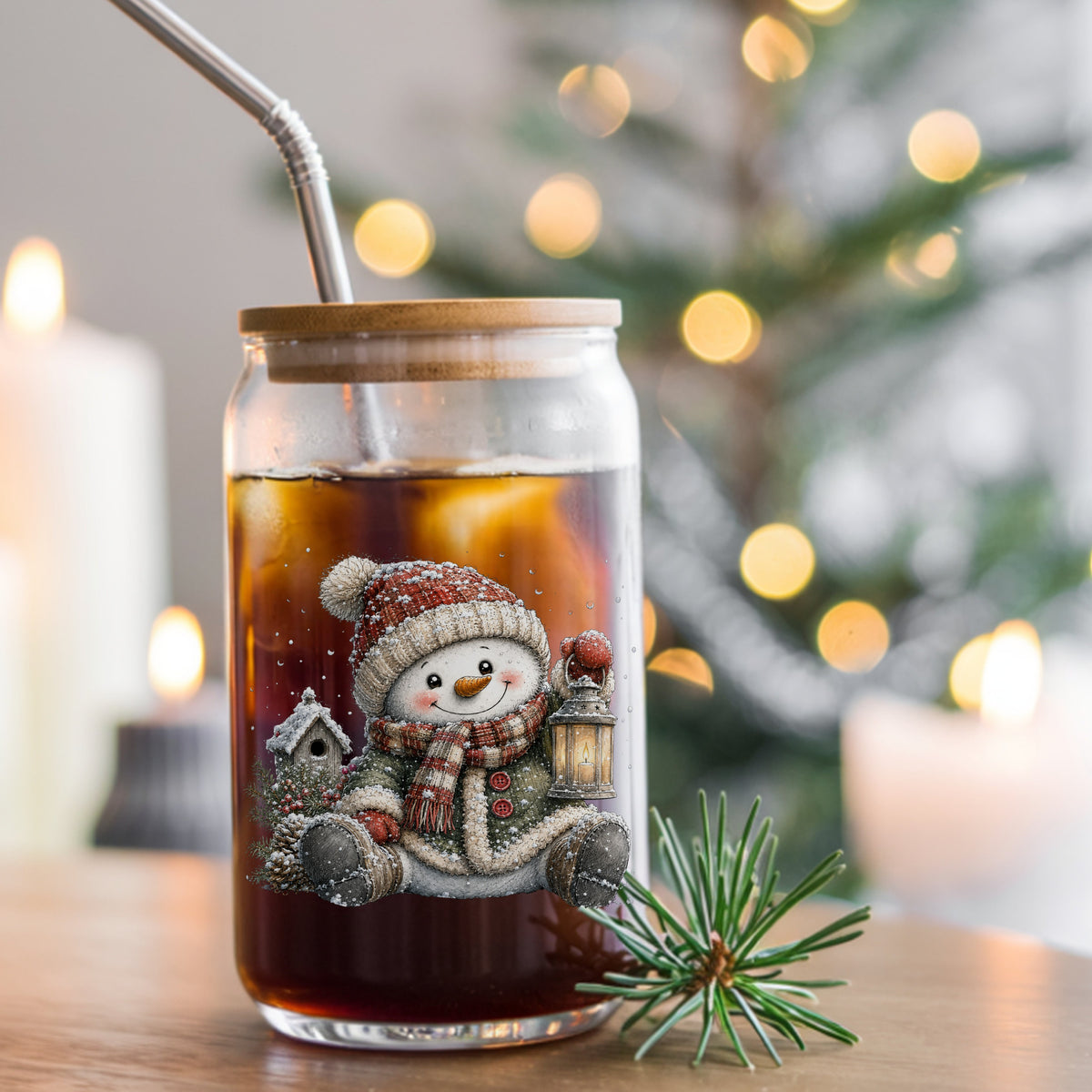 Sitting Snowman In Green Coat With Birdhouse UV DTF sticker applied to a glass can cup of iced coffee with a straw