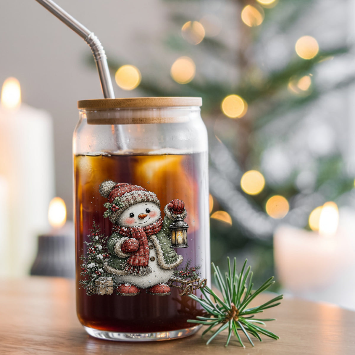 Snowman With Holly Hat And Christmas Tree UV DTF sticker applied to a glass can cup of iced coffee with a straw