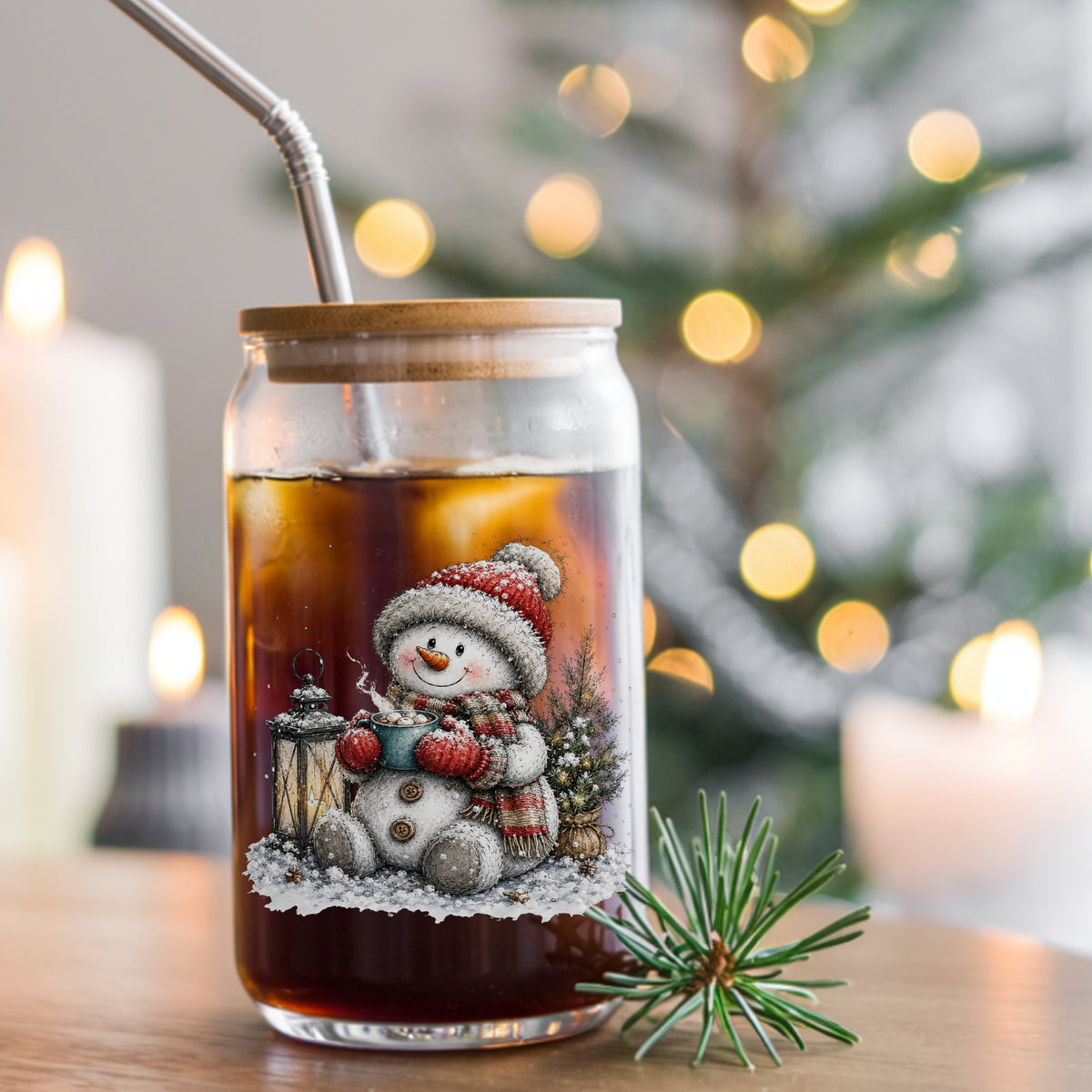 Snowman Sipping Cocoa By Lantern UV DTF sticker applied to a glass can cup of iced coffee with a straw