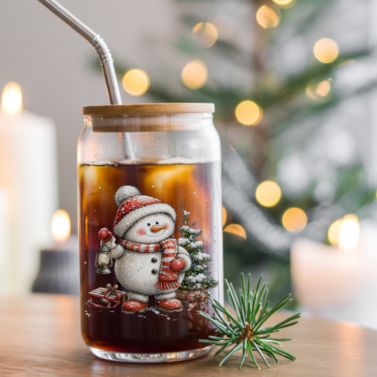 Striped Scarf Snowman With Lantern UV DTF sticker applied to a glass can cup of iced coffee with a straw