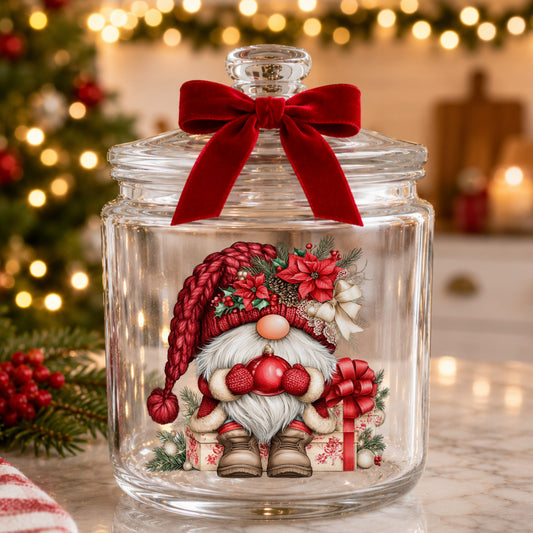 Gnome Holding Red Ornament UV DTF sticker applied to a glass candy jar tied with a red bow