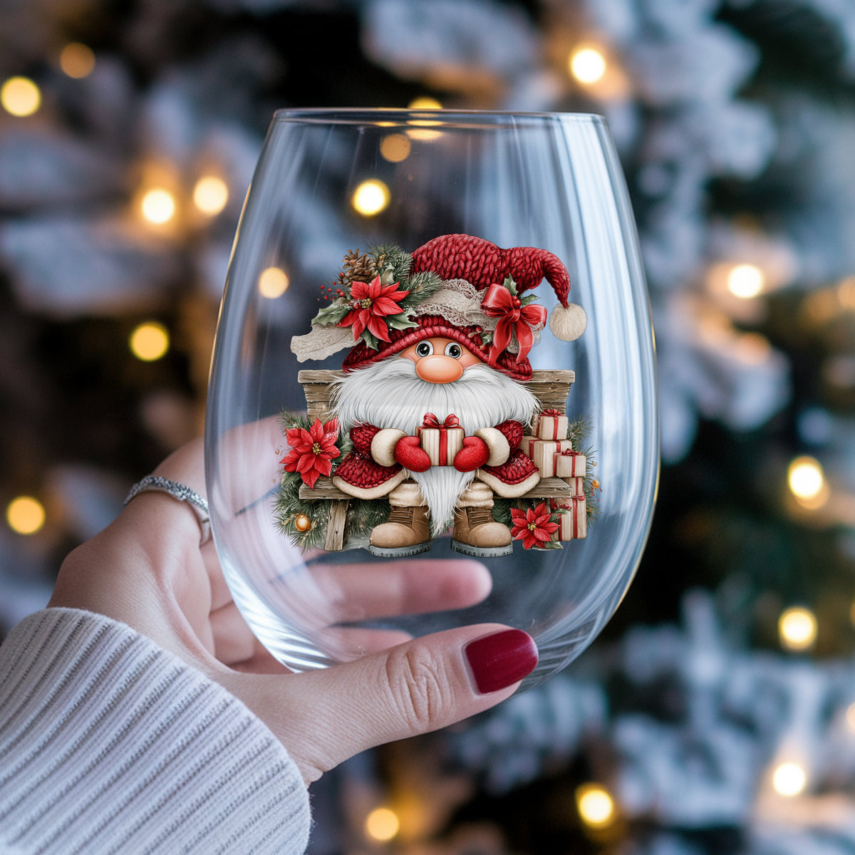 Gnome On Wooden Bench With Gifts UV DTF sticker applied to a stemless wine glass held in hand