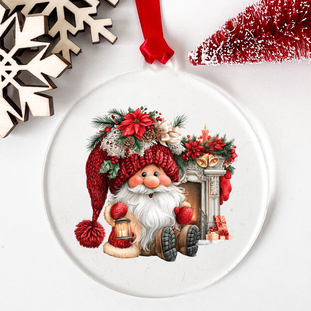 Gnome By Fireplace Mantel UV DTF sticker applied to a clear round acrylic ornament with a red ribbon