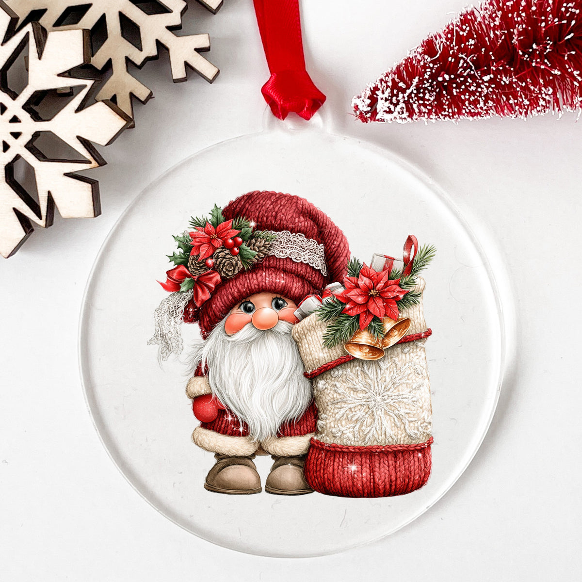 Gnome With Knit Christmas Stocking UV DTF sticker applied to a clear round acrylic ornament with a red ribbon