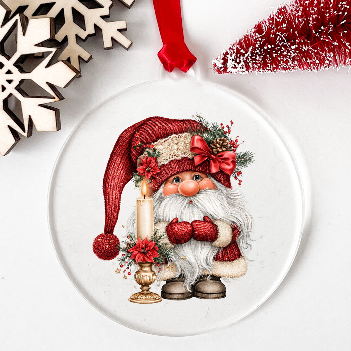 Gnome With Candle UV DTF sticker applied to a clear round acrylic ornament with a red ribbon