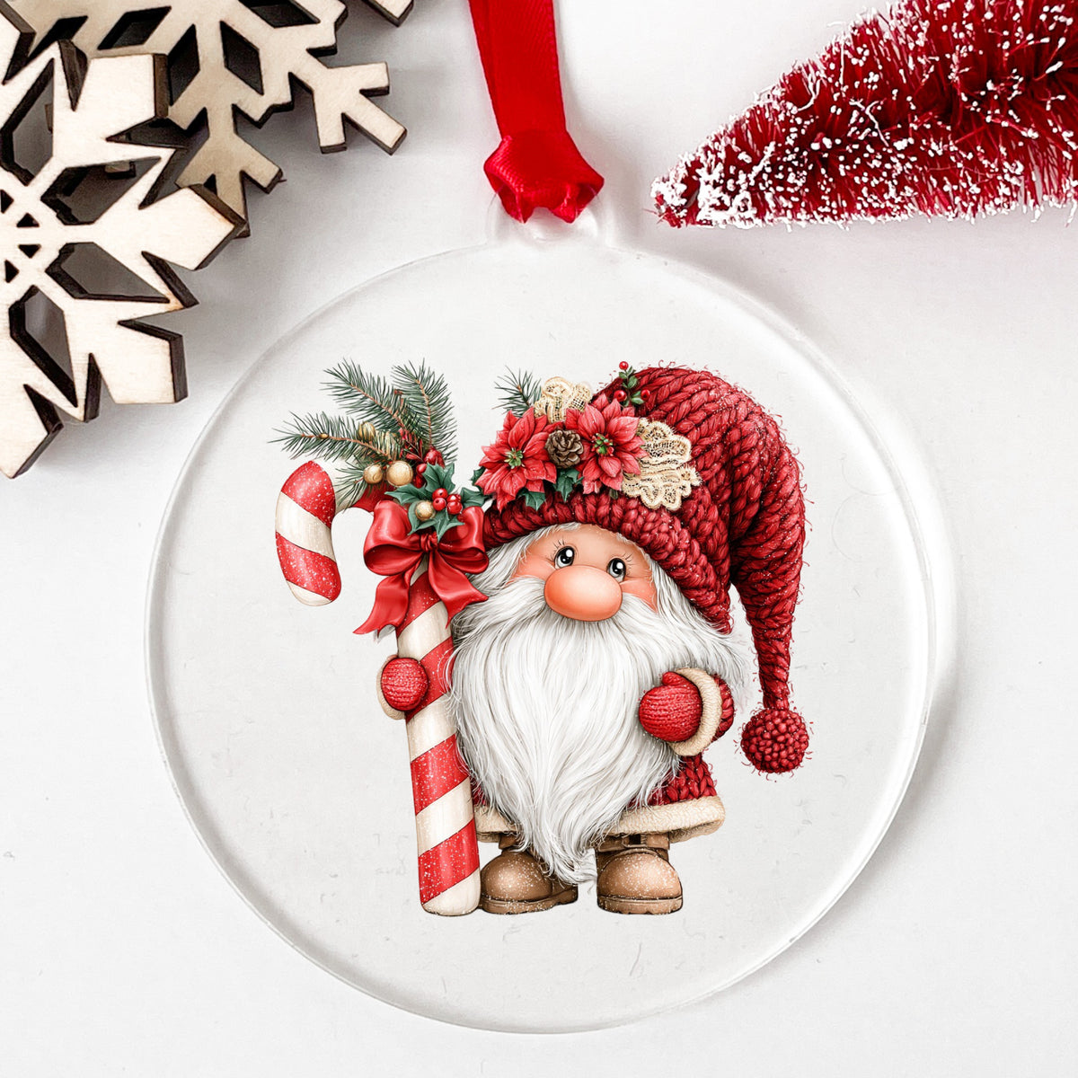 Candy Cane Gnome UV DTF sticker applied to a clear round acrylic ornament with a red ribbon