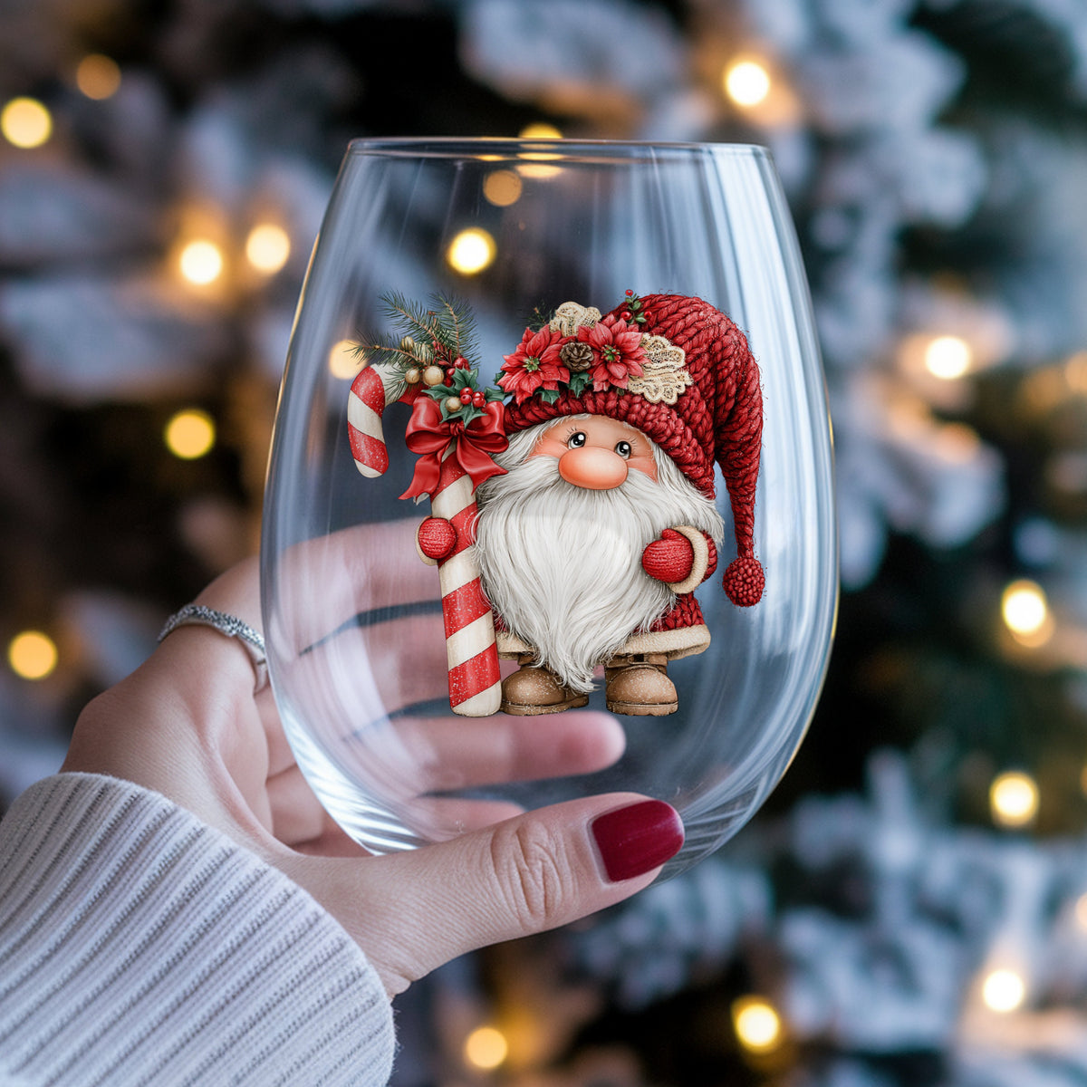 Candy Cane Gnome UV DTF sticker applied to a stemless wine glass held in hand