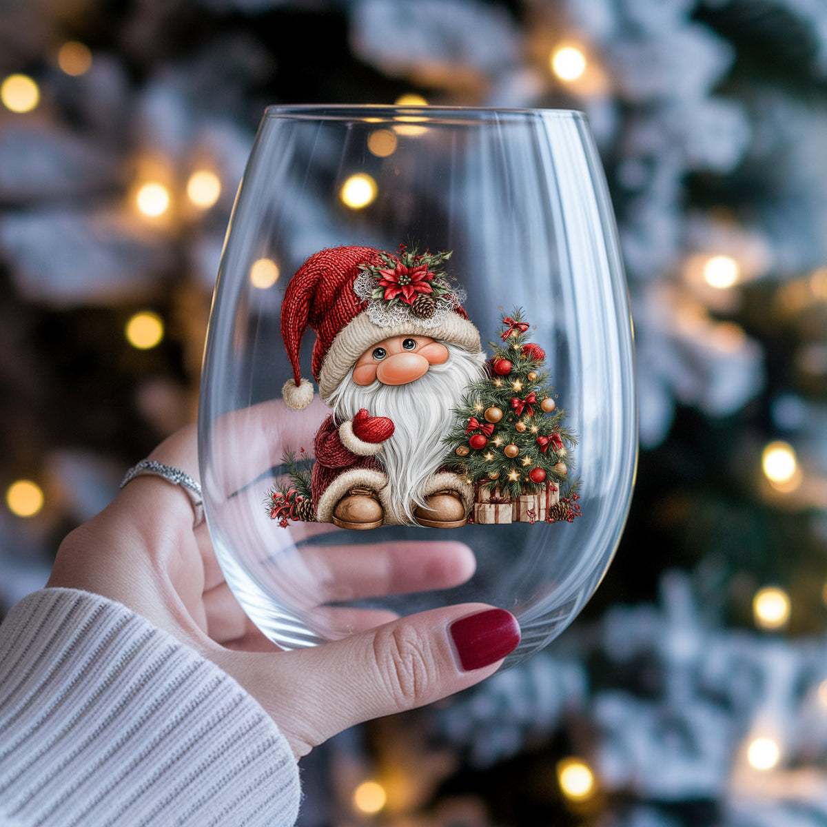 Gnome With Decorated Christmas Tree UV DTF sticker applied to a stemless wine glass held in hand