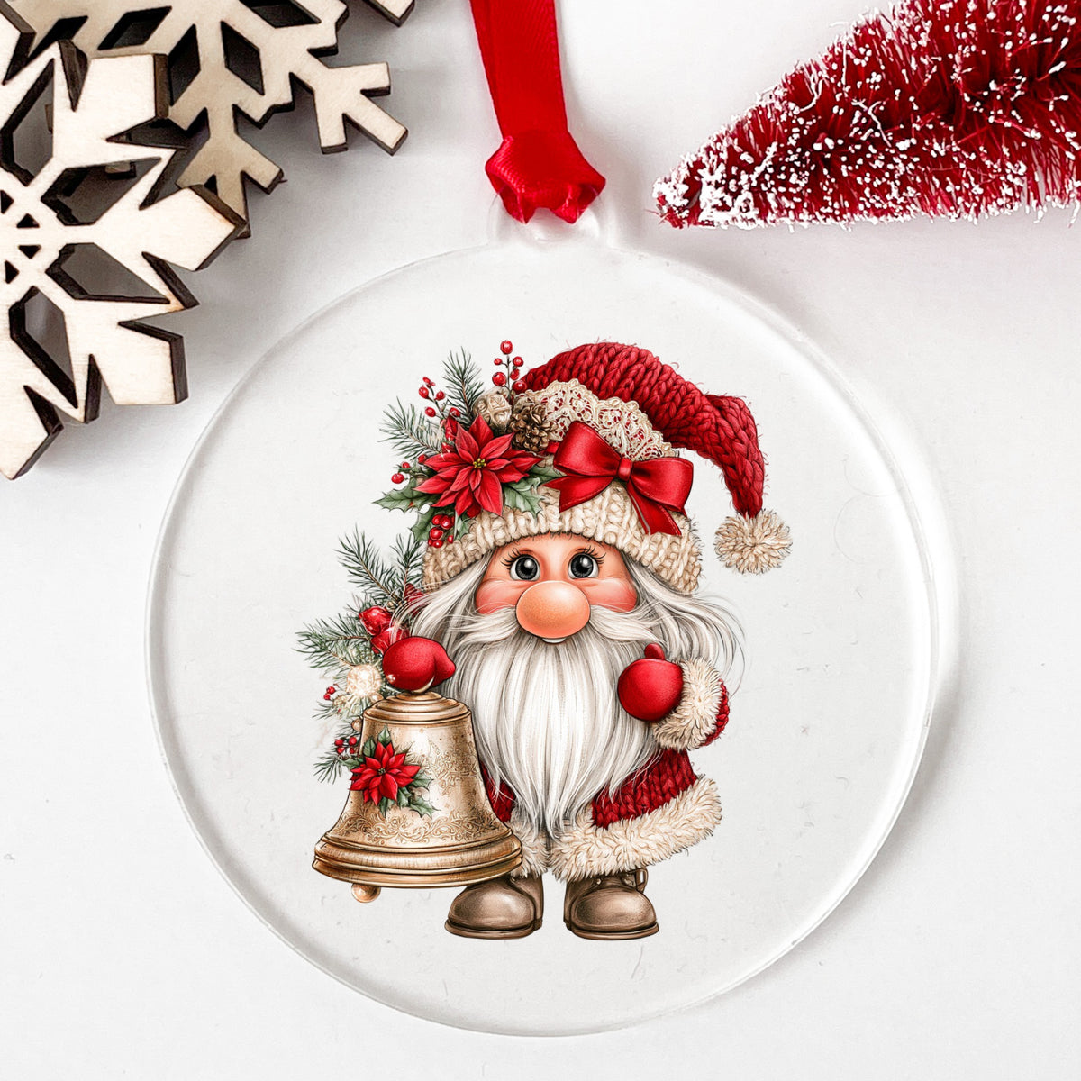 Gnome With Brass Bell UV DTF sticker applied to a clear round acrylic ornament with a red ribbon