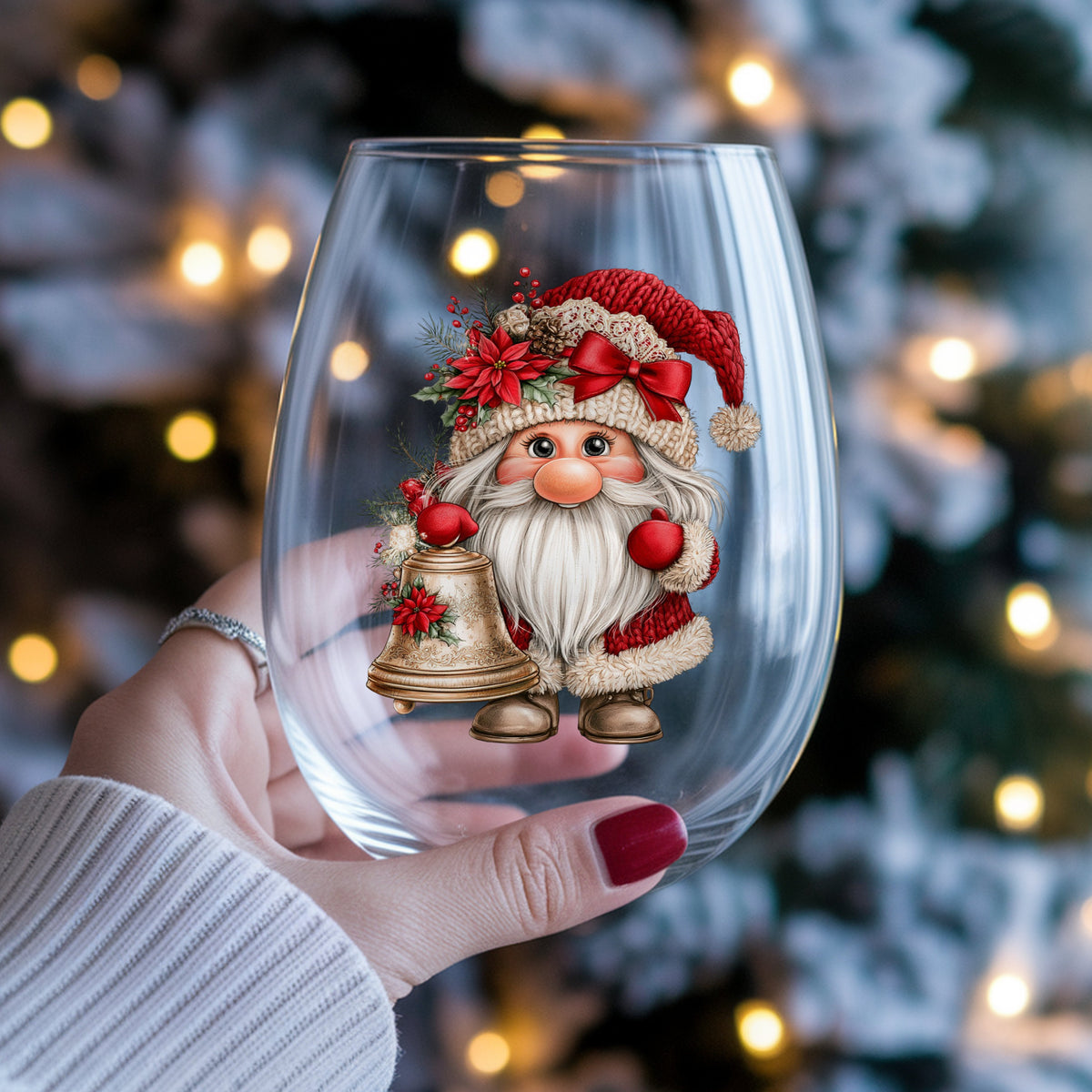 Gnome With Brass Bell UV DTF sticker applied to a stemless wine glass held in hand