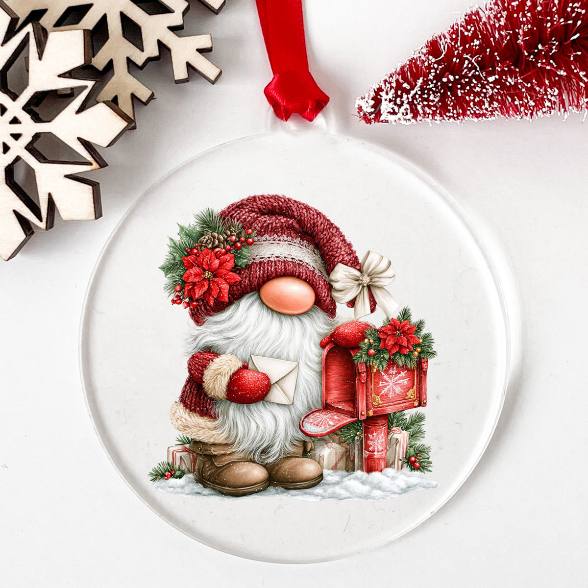 Gnome Mailing Letter At Red Mailbox UV DTF sticker applied to a clear round acrylic ornament with a red ribbon