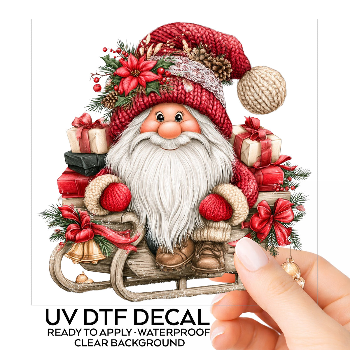 Gnome Riding Wooden Sleigh With Gifts UV DTF sticker on its backing card, held in hand