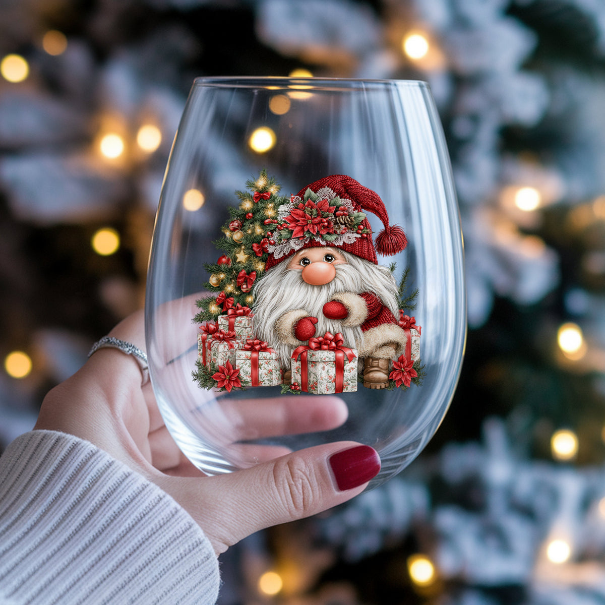 Gnome With Wrapped Presents And Lighted Tree UV DTF sticker applied to a stemless wine glass held in hand