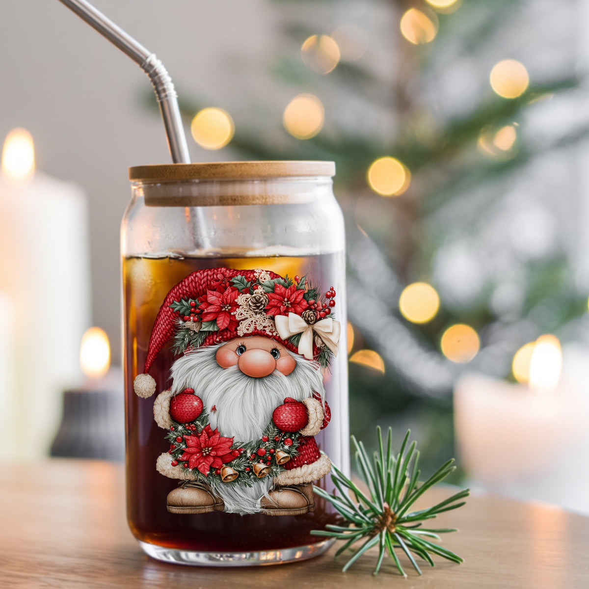 Gnome Holding Poinsettia Garland UV DTF sticker applied to a glass can cup of iced coffee with a straw