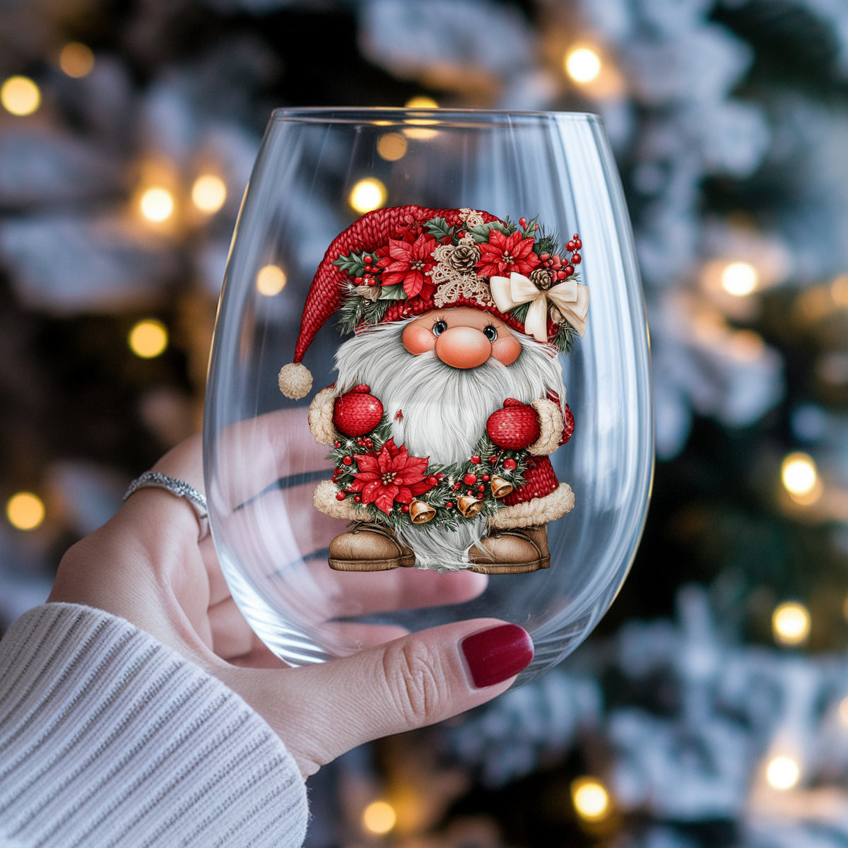 Gnome Holding Poinsettia Garland UV DTF sticker applied to a stemless wine glass held in hand