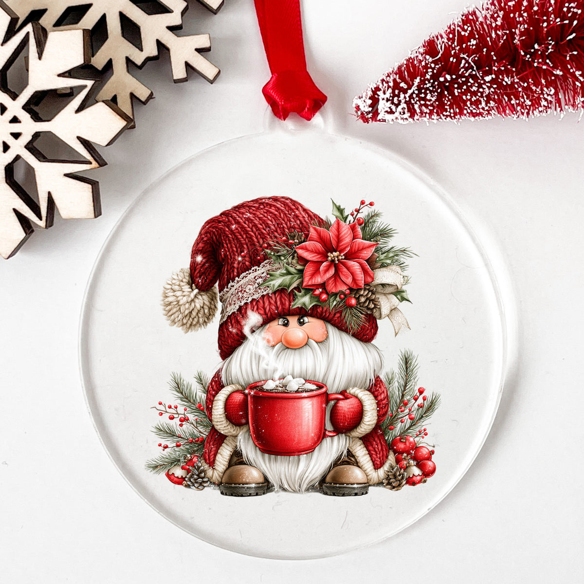 Hot Cocoa Gnome UV DTF sticker applied to a clear round acrylic ornament with a red ribbon