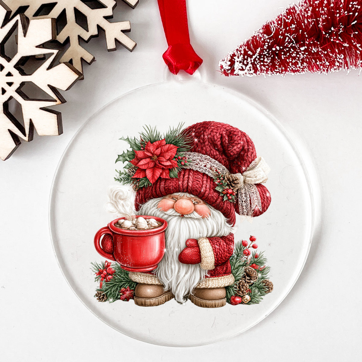 Sleepy Gnome With Big Red Mug UV DTF sticker applied to a clear round acrylic ornament with a red ribbon