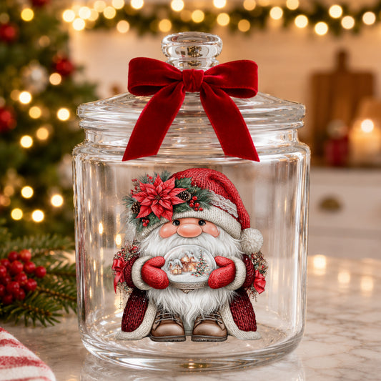 Gnome Holding Snow Globe UV DTF sticker applied to a glass candy jar tied with a red bow