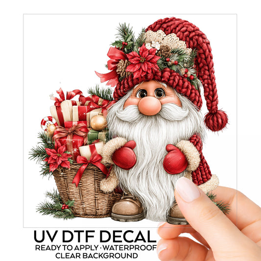 Gnome With Gift Basket UV DTF sticker on its backing card, held in hand