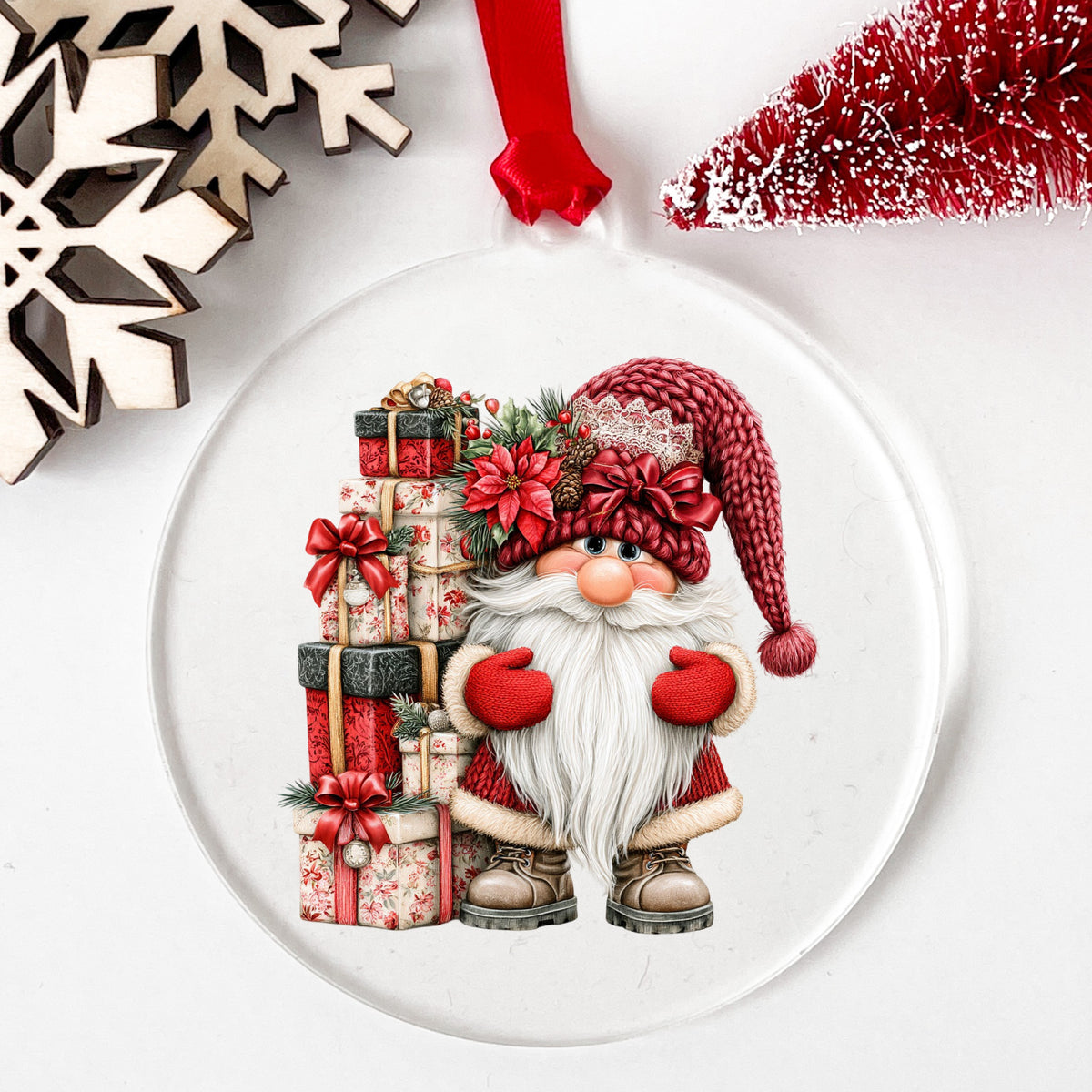 Gnome With Tall Floral Gift Tower UV DTF sticker applied to a clear round acrylic ornament with a red ribbon