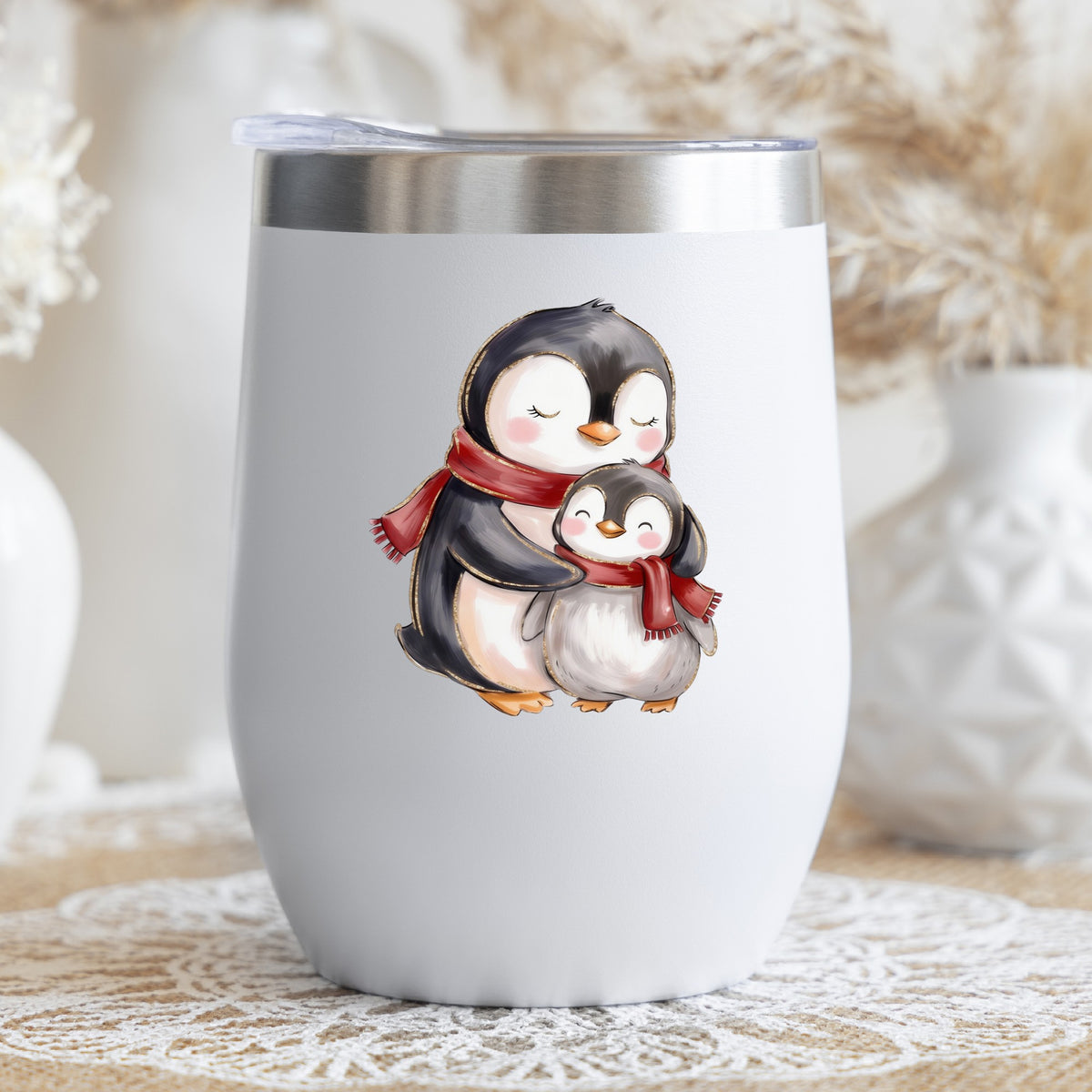Mama And Baby Penguin In Red Scarves UV DTF sticker applied to a white stemless tumbler with a lid