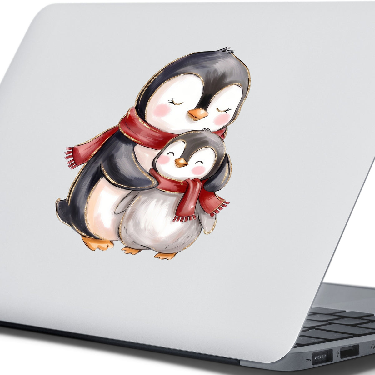 Mama And Baby Penguin In Red Scarves UV DTF sticker applied to the lid of a silver laptop