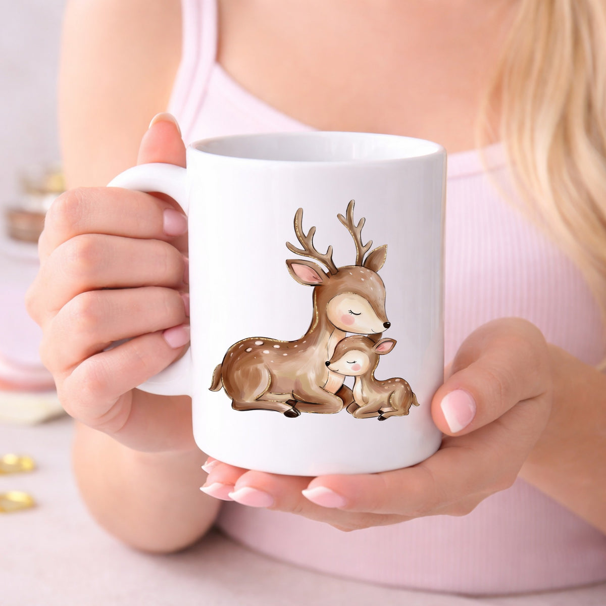 Mother Deer And Fawn UV DTF sticker applied to a white coffee mug held in both hands