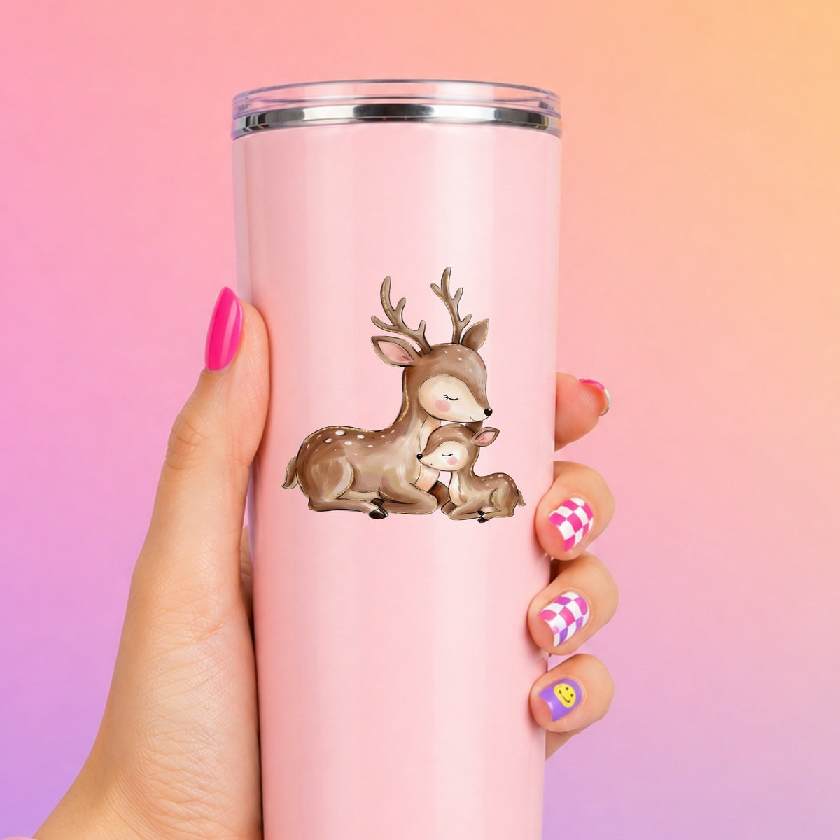 Mother Deer And Fawn UV DTF sticker applied to a tall pink tumbler on a pink and orange background