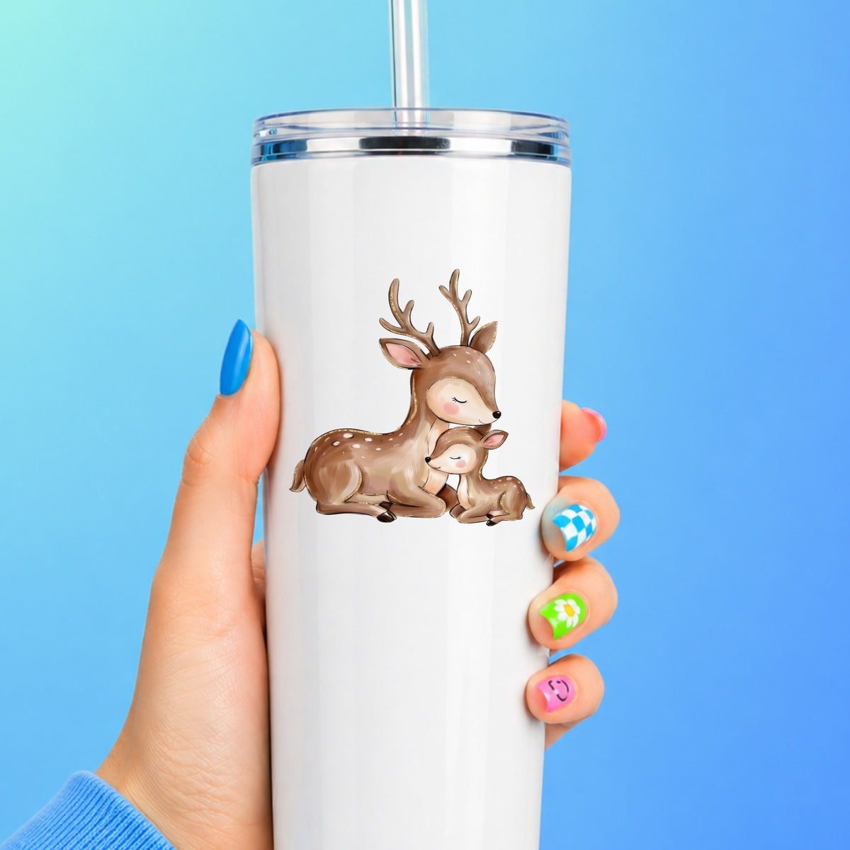 Mother Deer And Fawn UV DTF sticker applied to a white straw tumbler on a blue background